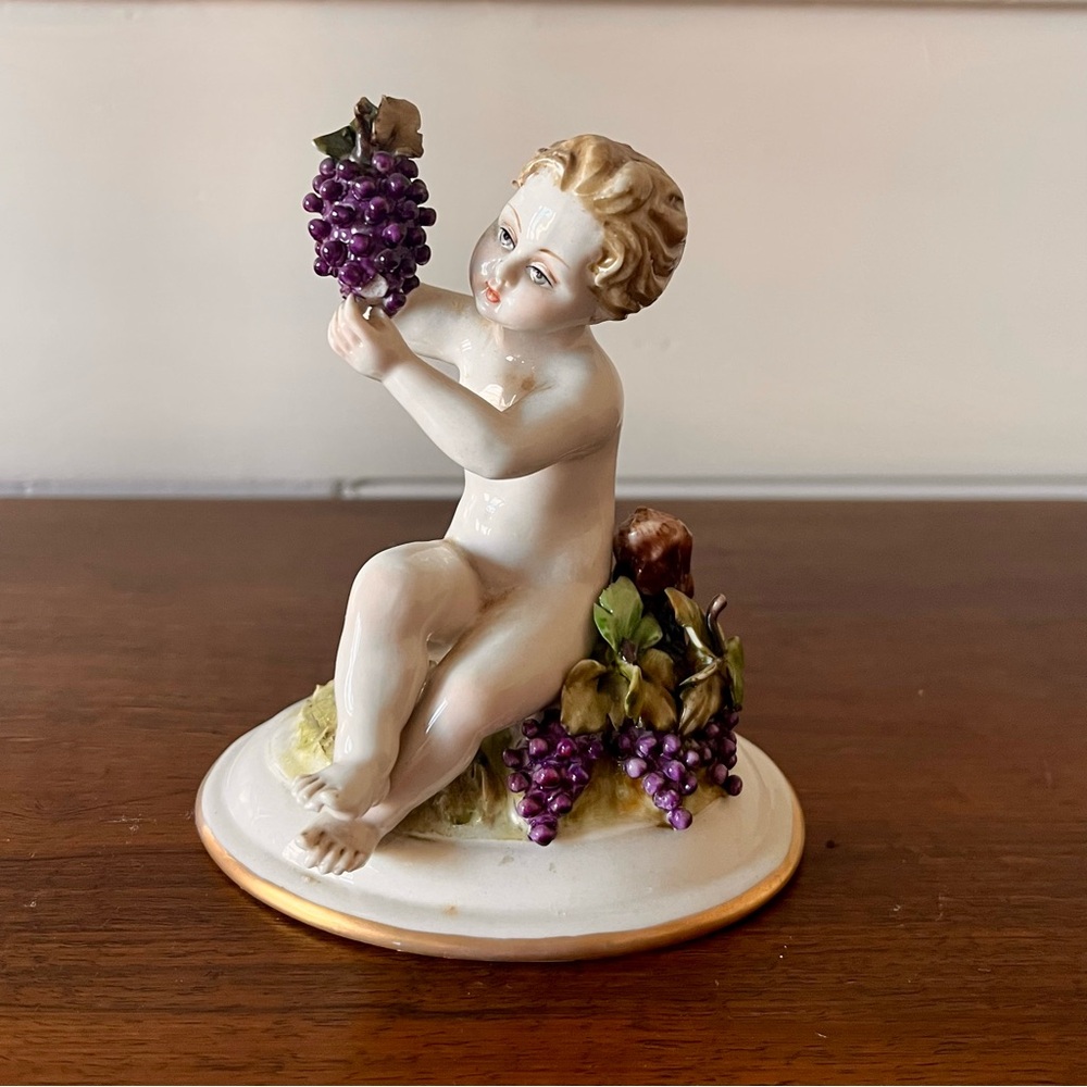 Antique Porcelain Capodimonte Putti or Cherub Figure Holding Grapes